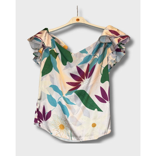 Blusa campesina con estampado floral vibrante sobre fondo claro. Talla S